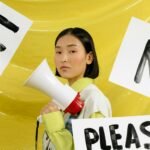 woman in white long sleeve shirt holding white ceramic mug